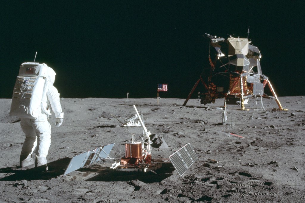 In this July 20, 1969, photo, astronaut Buzz Aldrin Jr. stands next to the Passive Seismic Experiment device on the surface of the moon during the Apollo 11 mission. 