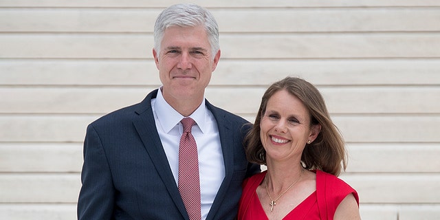 Justice Neil Gorsuch stands with his wife Marie Louise Gorsuch on the steps of the U.S. Supreme Court in Washington, D.C., June 15, 2017. 