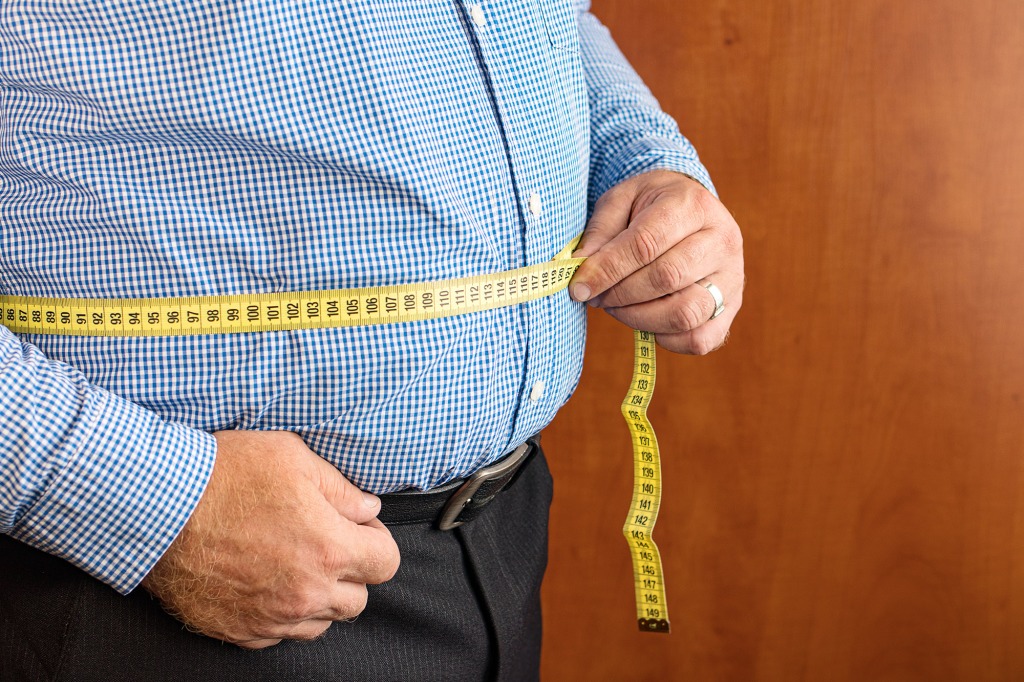 Man measuring stomach