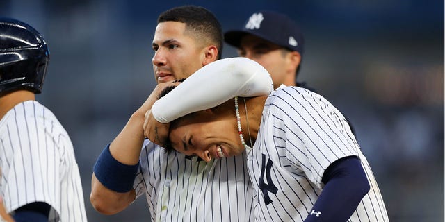 Gleyber Torres #25 and Oswaldo Cabrera #95 of the New York Yankees celebrate after Cabrera singled in the twelfth inning, sending Isiah Kiner-Falefa #12 home to defeat the Minnesota Twins at Yankee Stadium on Wednesday, Sept. 7, 2022 in New York, New York.