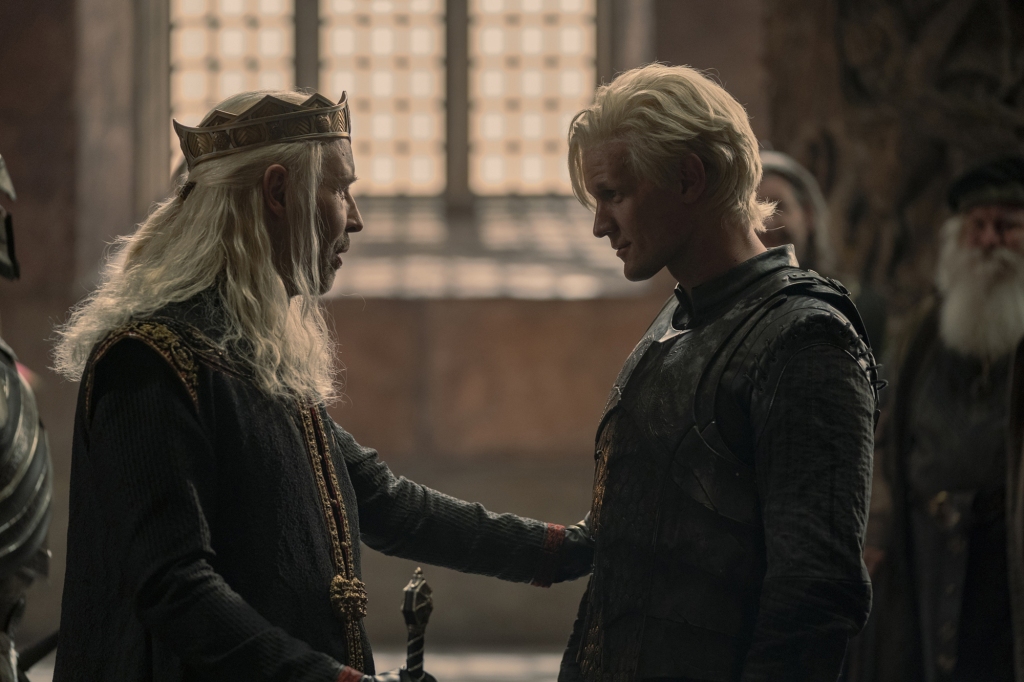 King Viserys (Paddy Consideine) and his younger brother Daemon (Matt Smith) face each other smiling. 