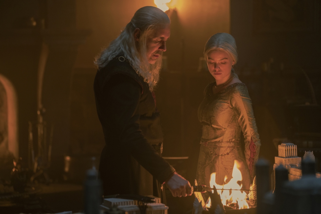 Rhaenyra (Milly Alcock), right, with her dad King Viserys (Paddy Considine) looking at fire. 