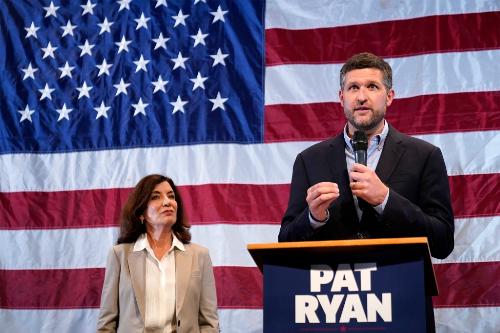 Democratic candidate Pat Ryan, right, and New York Gov. Kathy Hochul appear on stage together during a campaign rally .