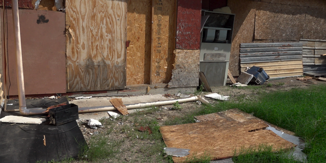 Plywood ripped from the side of the Wagon Wheel lays next to a recently boarded off section of the former business. 