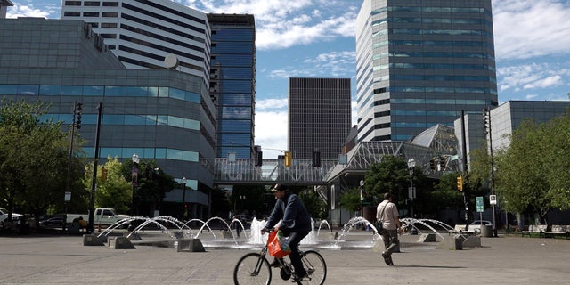 A bicyclist rides past Salmon Street Springs Sept. 7, 2022, in Portland, Oregon. Many residents of the city say they're worried about being attacked while walking around town.