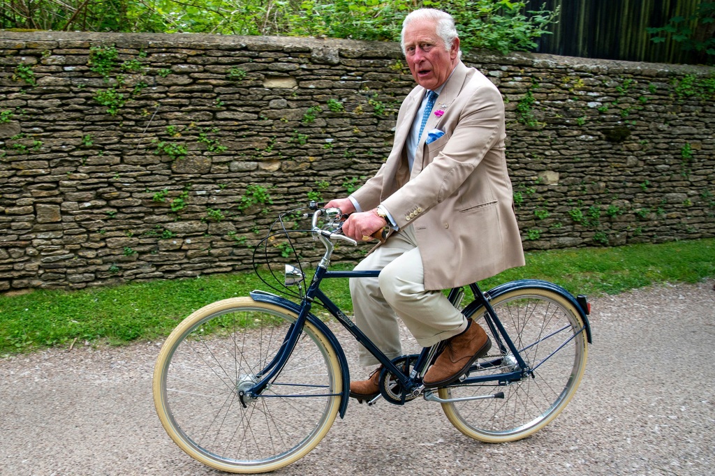 A picture of King Charles III riding a bike.