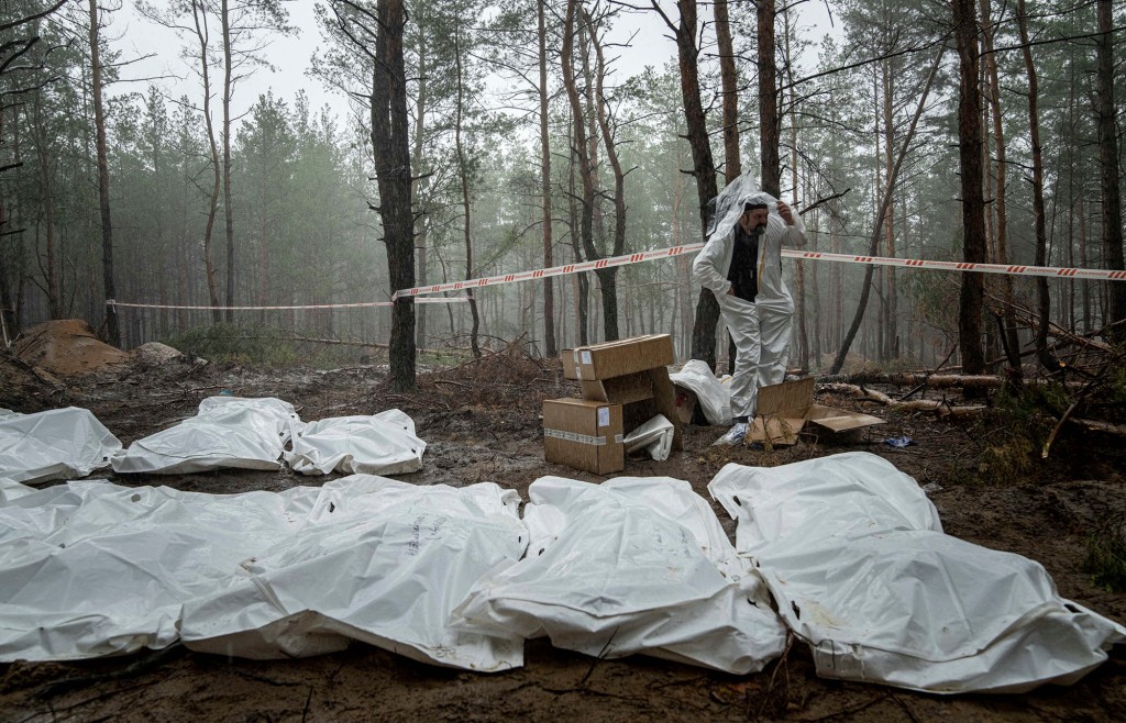 Bags with dead bodies are seen during the exhumation in the recently retaken area of Izium, Ukraine, Friday, Sept. 16, 2022