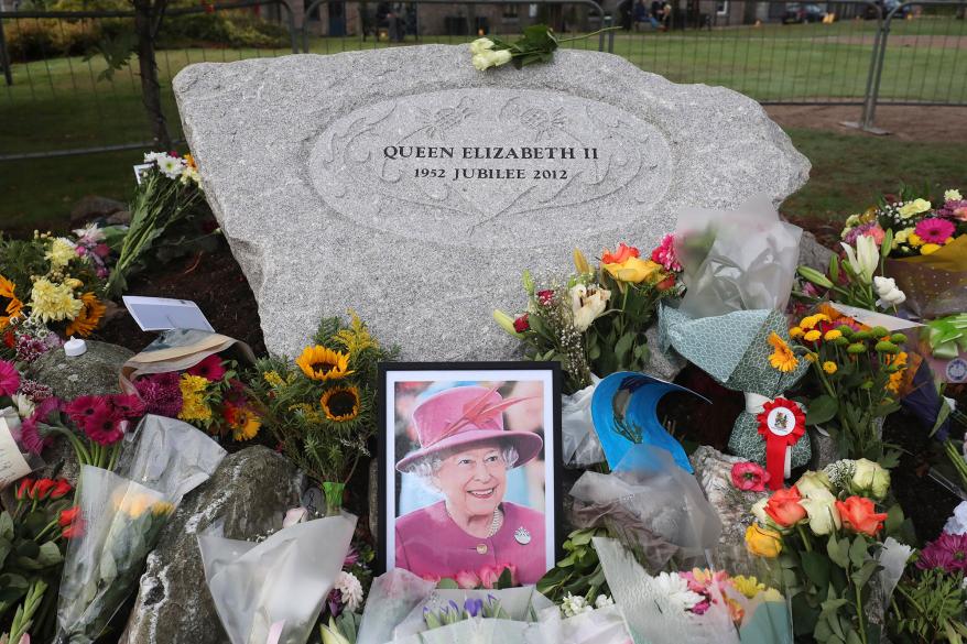 Floral tributes are placed in Ballater, Scotland.