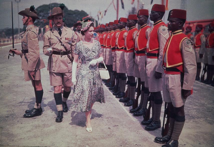 In 1956, Queen Elizabeth walked by a row of the men of the newly-renamed Queen's Own Nigeria Regiment, Royal West African Frontier Force, at Kaduna Airport in Nigeria, during her Commonwealth Tour.