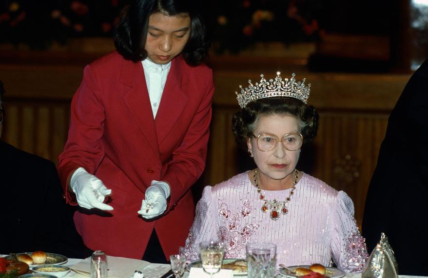 A server offered Queen Elizabeth, who wore what became known as Granny's Tiara, chopsticks during a 1986 state banquet in Peking, China. She also donned a dress printed with peonies, China's national flower.