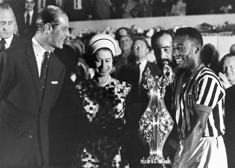 Queen Elizabeth, with Prince Philip, presented a winning cup to Brazilian soccer player Pelé at a stadium in Rio de Janeiro, during a 1986 state tour of South America.