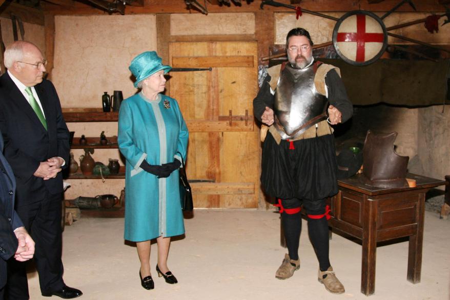 A picture of Queen Elizabeth II viewed a replica of the armory with actor Fred Scholpp.