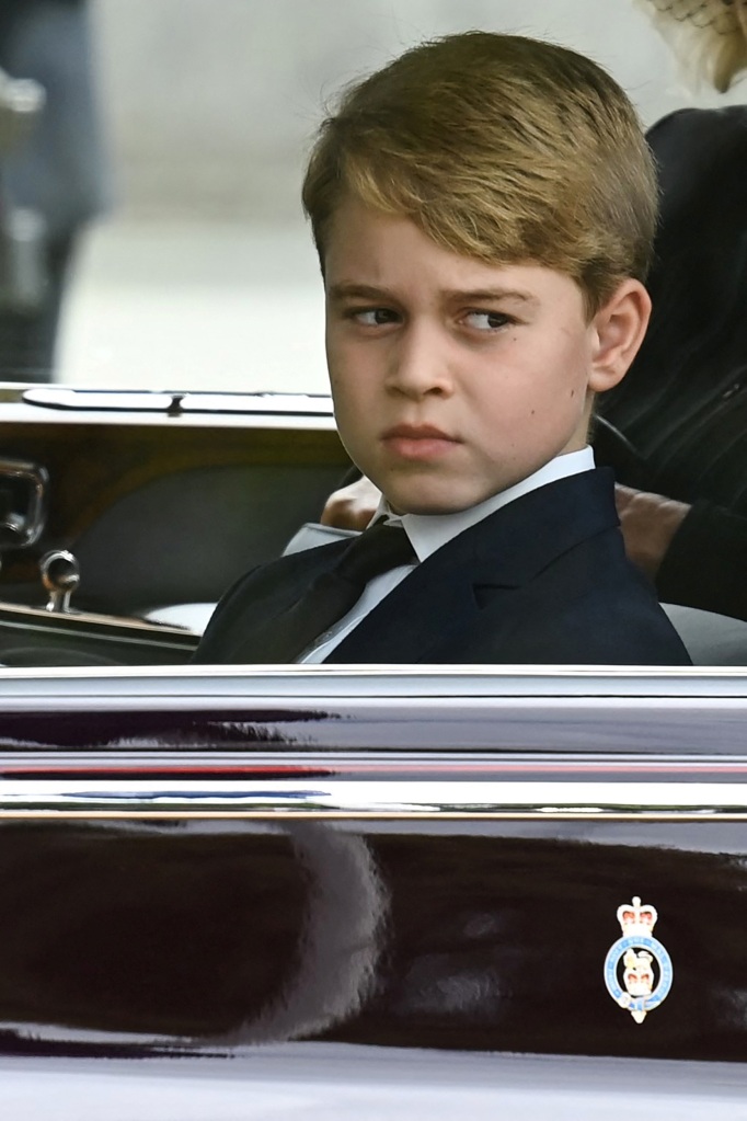 Britain's Prince George of Wales looks from a car window in the Procession following the coffin of Queen Elizabeth II, travelling from Westminster Abbey to Wellington Arch.