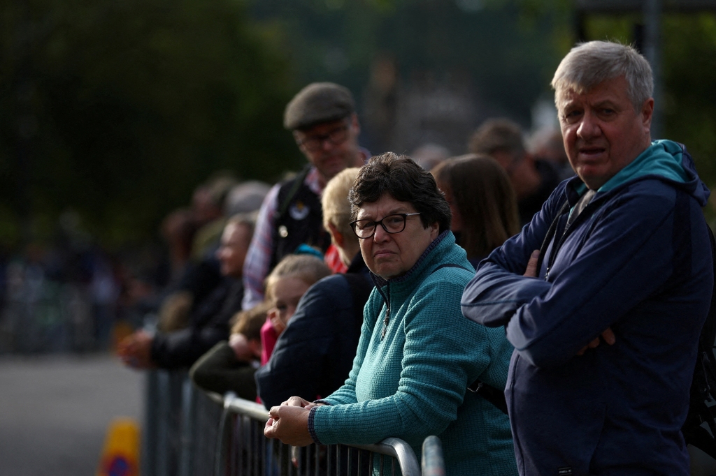 People line the street waiting for the funeral cortege carrying Britain's Queen Elizabeth in the village of Ballater, following the Queen's passing, near Balmoral, Scotland on Sept. 11, 2022.