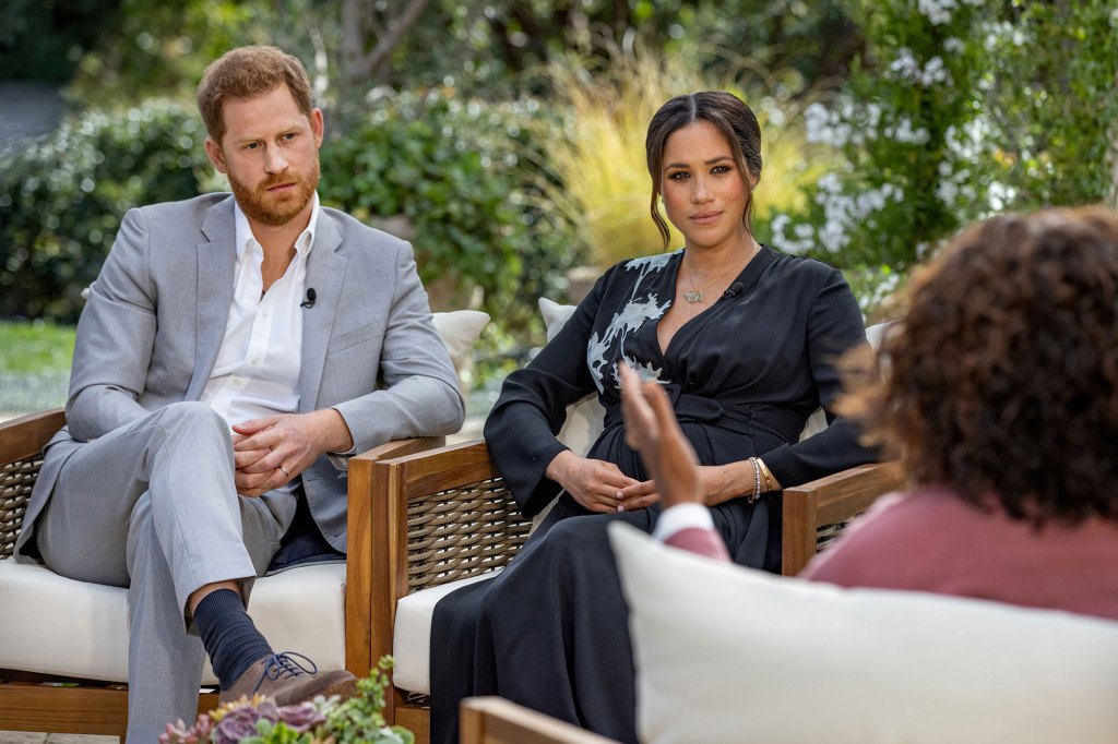 A photo of Prince Harry, Meghan Markle, and Oprah sitting together.