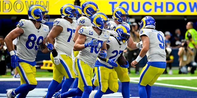 Matthew Stafford #9 of the Los Angeles Rams congratulates Darrell Henderson Jr #27 after rushing for a touchdown  during the second quarter against the Atlanta Falcons at SoFi Stadium on September 18, 2022 in Inglewood, California.