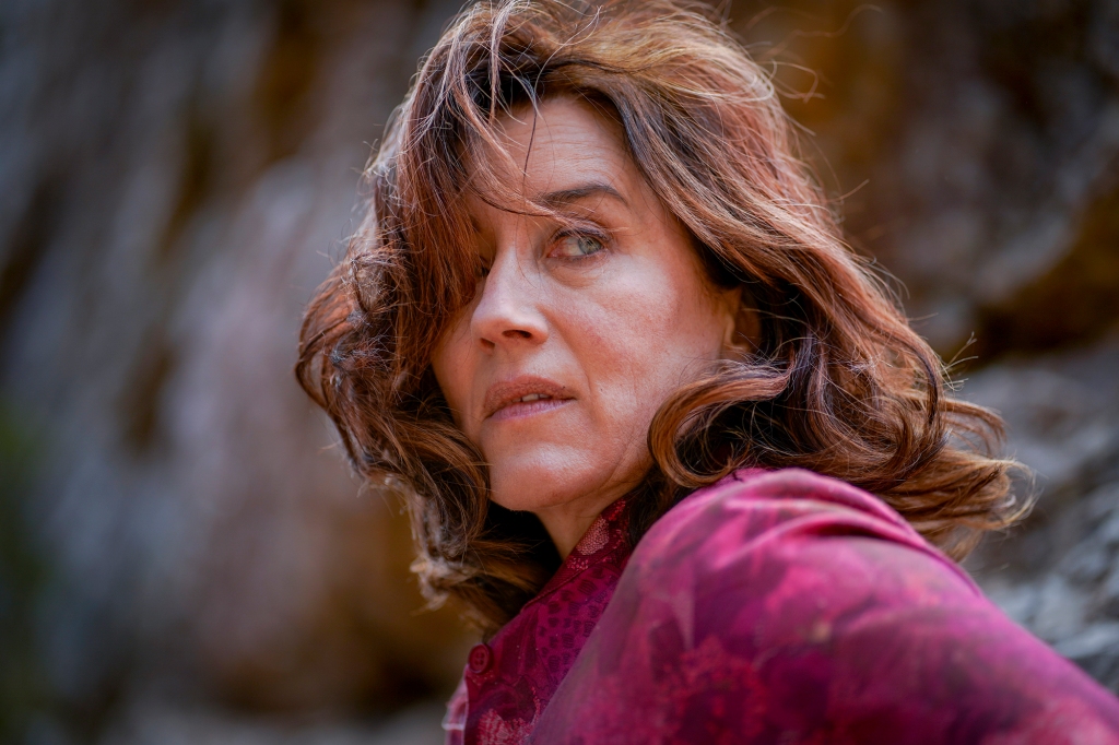 Maria Doyle Kennedy as Tannie Marie Purvis. She's looking off-camera and her hair is covering one of her eyes. She looks frightened, like someone is chasing her.