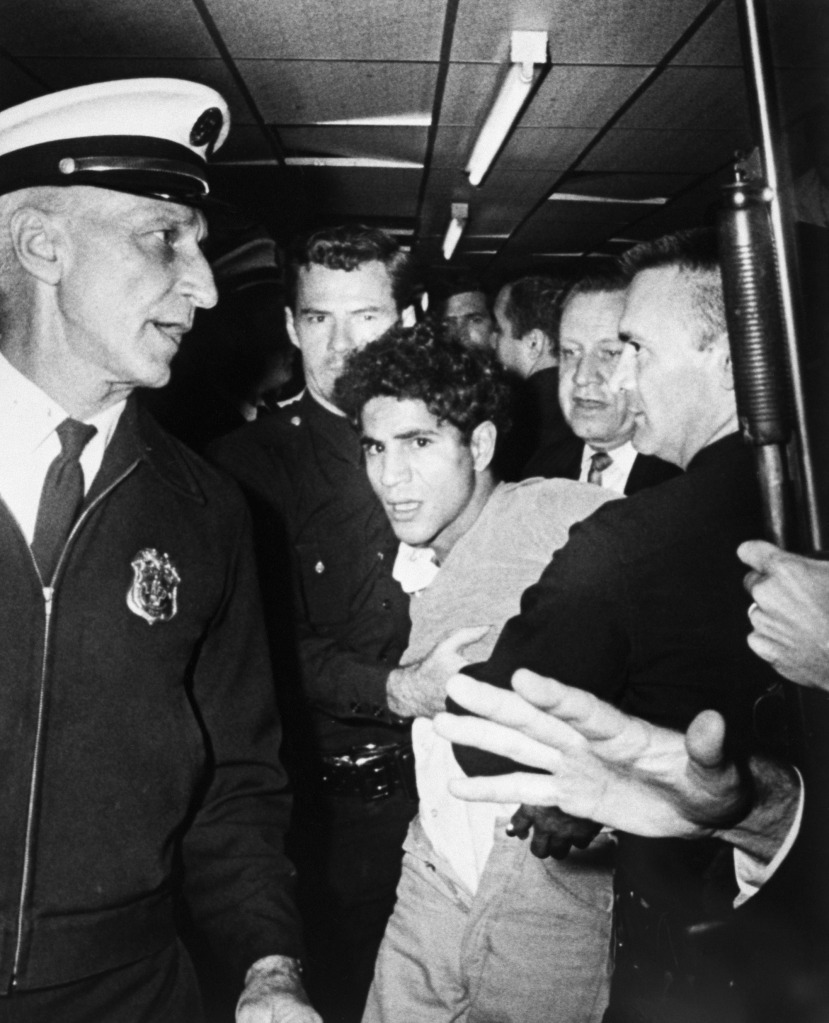 Sirhan Sirhan is led away from the Ambassador Hotel after shooting Robert F. Kennedy.
