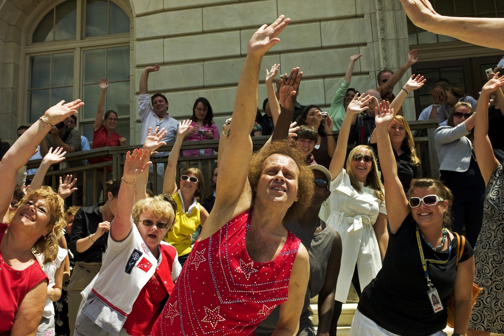 WASHINGTON, DC - July 24: Fitness advocate Richard Simmons leads a crowd of fans in a short workout during a rally at the U.S. Capitol, after testifying at a hearing before the House Education and Labor Committee to promote fitness and health education for children. (Photo by Scott J. Ferrell/Congressional Quarterly/Getty Images)