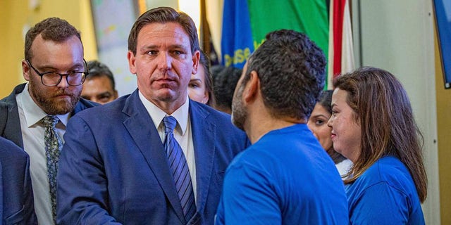 Florida Gov. Ron DeSantis shakes hands with a member of the Florida Department of Transportation while leaving a press conference regarding toll relief at the Florida Department of Transportation District 6 Headquarters in Miami on Wednesday, Sept. 7, 2022. (Sydney Walsh/Miami Herald/Tribune News Service via Getty Images)