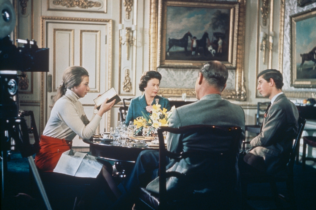 Queen Elizabeth II lunches with Prince Philip and their children Princess Anne and Prince Charles at Windsor Castle in Berkshire, circa 1969. A camera (left) is set up to film for Richard Cawston's BBC documentary 'Royal Family', which followed the Royal Family over a period of a year and was broadcast on 21st June 1969. (Photo by Hulton Archive/Getty Images)