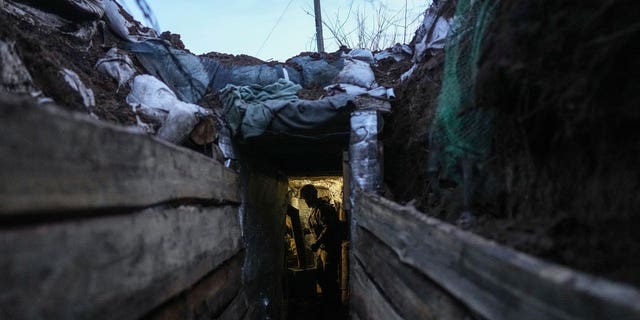 A Ukrainian serviceman stands in a shelter at the line of separation between Ukraine-held territory and rebel-held territory near Zolote, Ukraine, Feb. 19, 2022. 