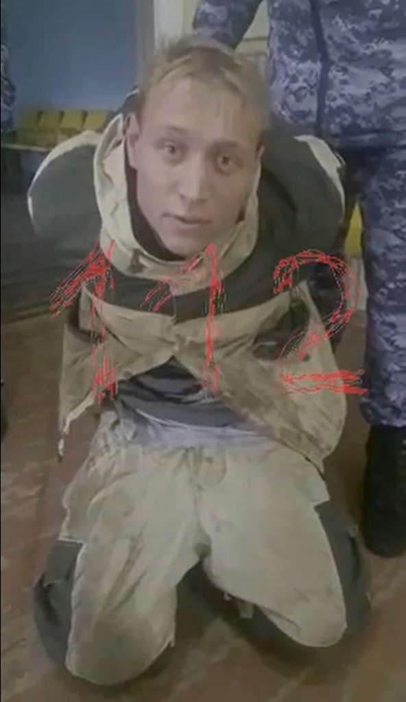 Gunman Ruslan Zinin on his knees after shooting.