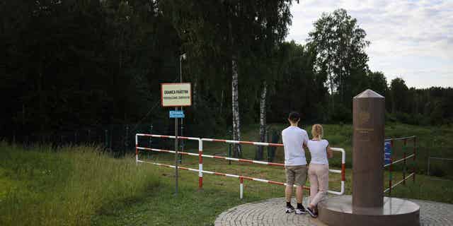 People are seen on the tri-point boarder of Poland, Lithuania and Russia on June 7, 2022, which has now been closed off to Russian's fleeing the military draft in their country.