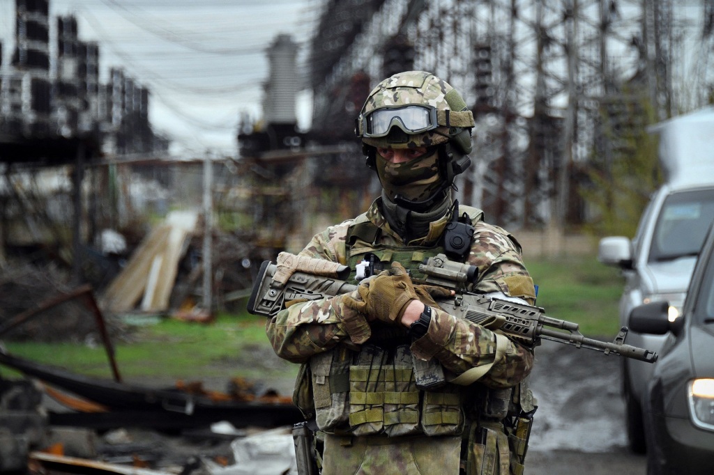 A Russian soldier stands guard at the Luhansk power plant in the town of Shchastya