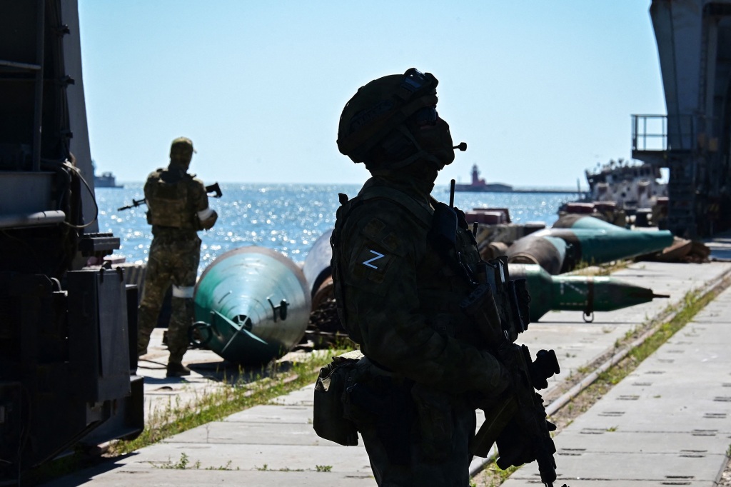 Russian servicemen patrol a territory of the sea port in the city of Mariupol on June 12, 2022, amid the ongoing Russian military action in Ukraine.