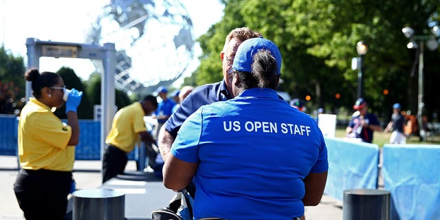 Fans gather outside of security to enter the venue on Day Two of the 2016 US Open at the USTA Billie Jean King National Tennis Center on August 30, 2016, in the Flushing neighborhood of the Queens borough of New York City.
