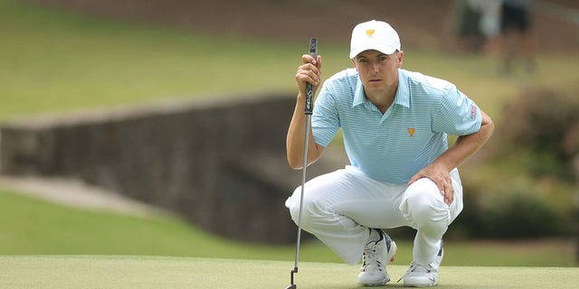 Jordan Spieth of the United States Team lines up his putt on the tenth hole during the Thursday foursome matches on day one of the 2022 Presidents Cup at Quail Hollow Country Club on September 22, 2022 in Charlotte, North Carolina.