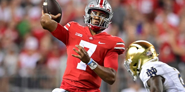 Ohio State quarterback C.J. Stroud throws while being pressured by Notre Dame safety DJ Brown during the second quarter of an NCAA college football game Saturday, Sept. 3, 2022, in Columbus, Ohio.