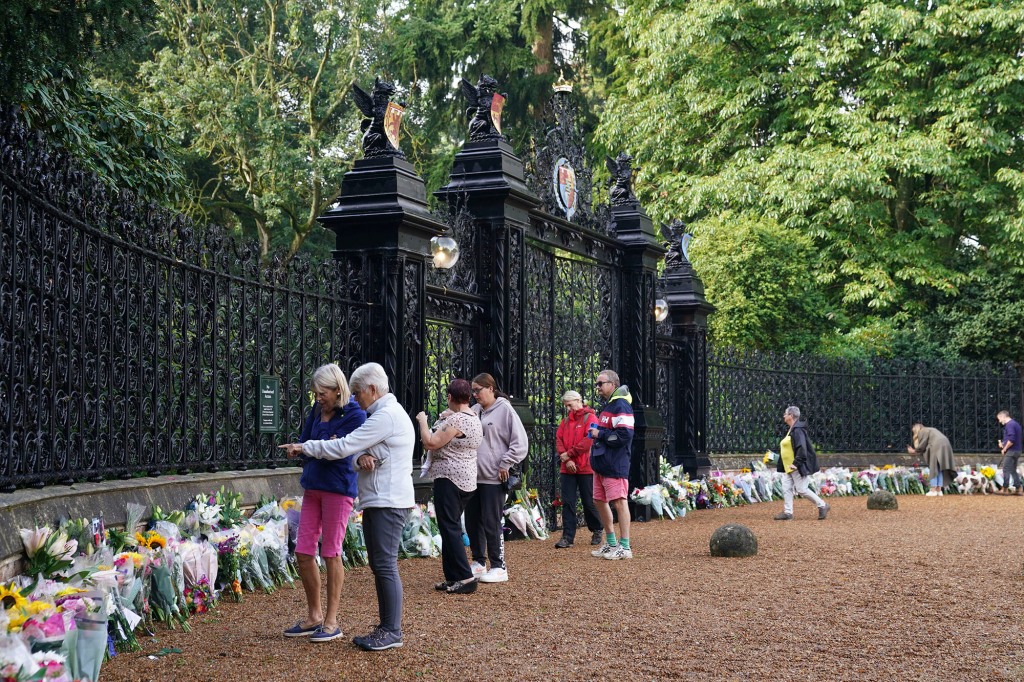 Mourners gather to lay flowers and pay their respects at the Sandringham Estate in Norfolk following the death of Queen Elizabeth II on Sept. 9, 2022. 