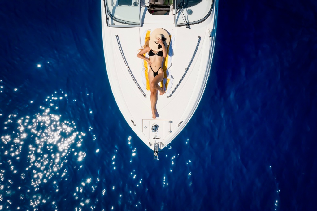 Overhead of a bikinied woman on a yacht. 