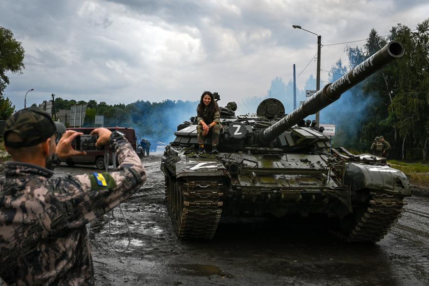 Ukrainian service members and volunteers pose for a picture.