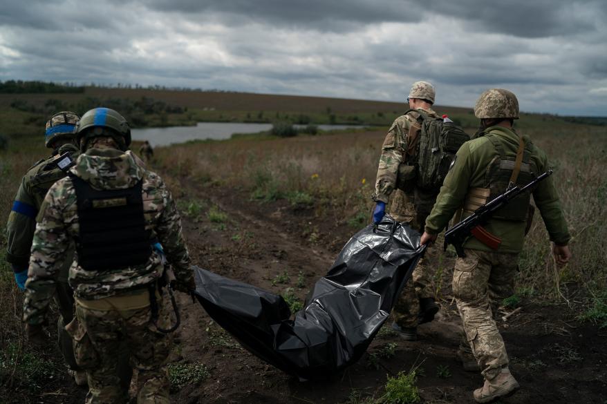 Ukrainian national guard servicemen carry the body of a dead Ukrainian soldier near Kharkiv, Ukraine.