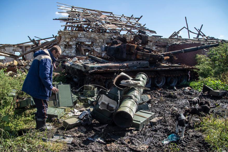 A local resident stares at his house destroyed by a Russian tank in Izium, Ukraine.