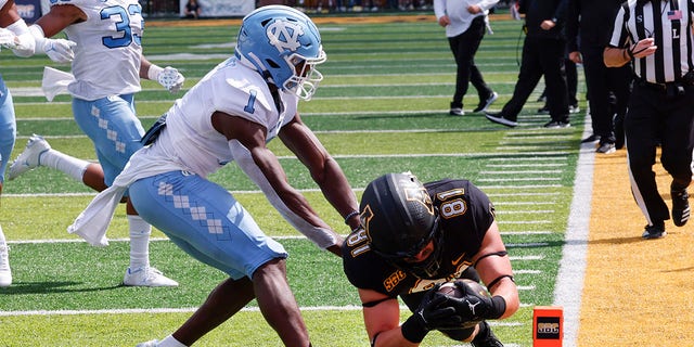 Appalachian State tight end Miller Gibbs (81) dives in for a touchdown past North Carolina defensive back Tony Grimes (1) during the second half of an NCAA college football game, Saturday Sept. 3, 2022, in Boone, N.C.