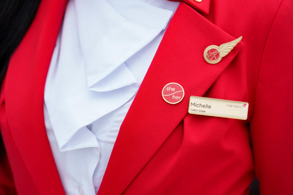 Tyreece Nye, a non-binary TikToker, left, is pictured modeling a Vivienne Westwood-designed Virgin Atlantic uniform featuring a skirt. 