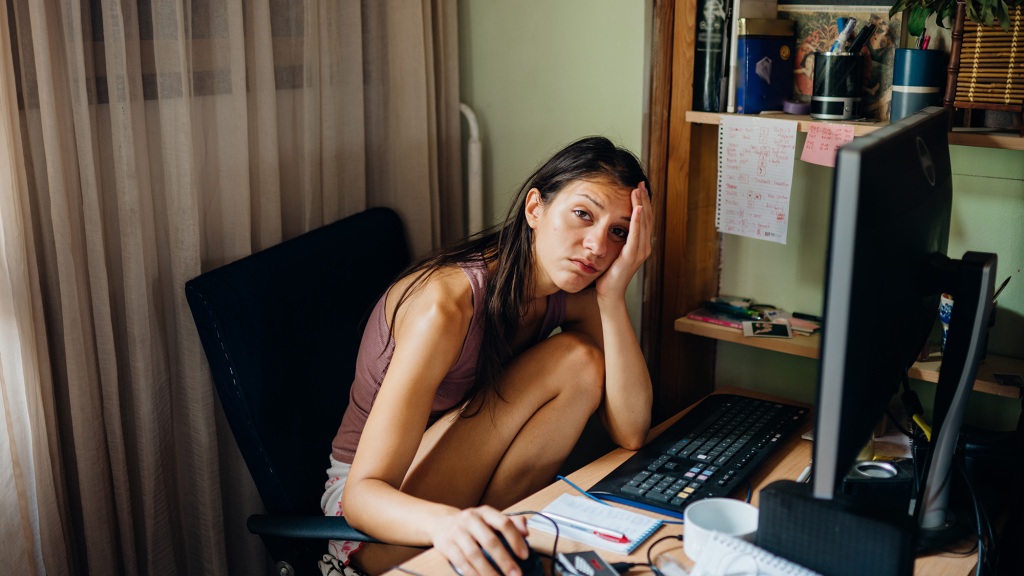 Tired-looking woman at a desk