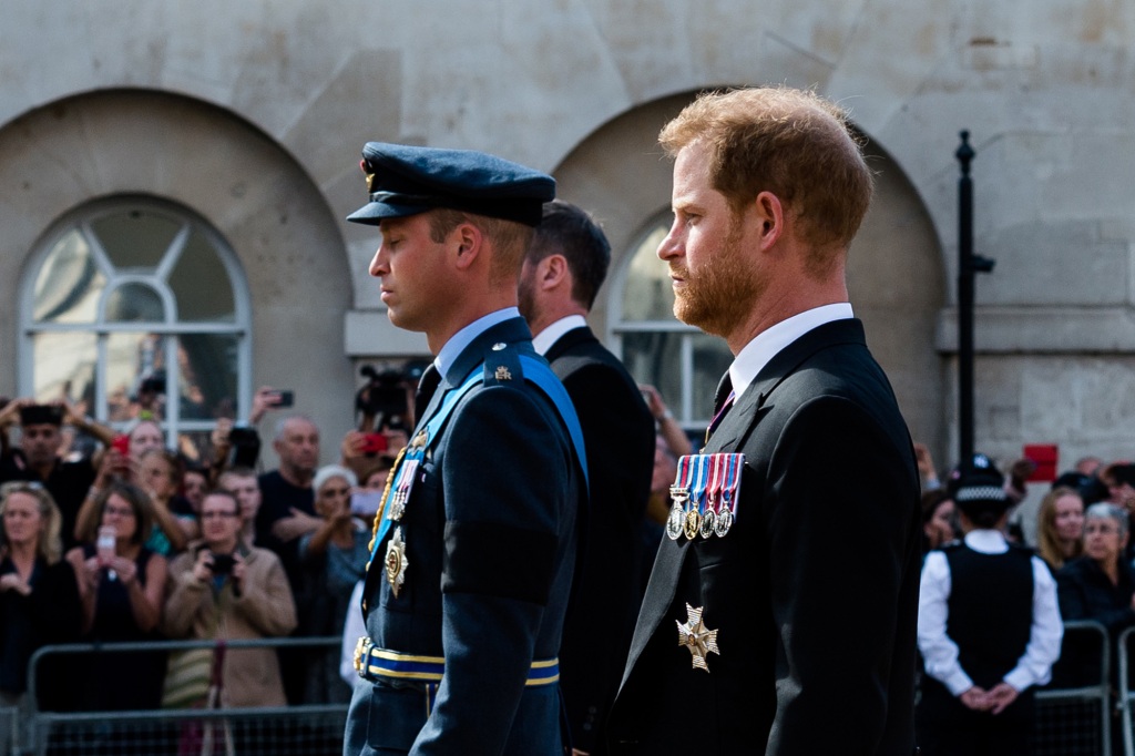 William, Prince of Wales (L) and Prince Harry, Duke of Sussex (R) walk behind the coffin of Queen Elizabeth II.