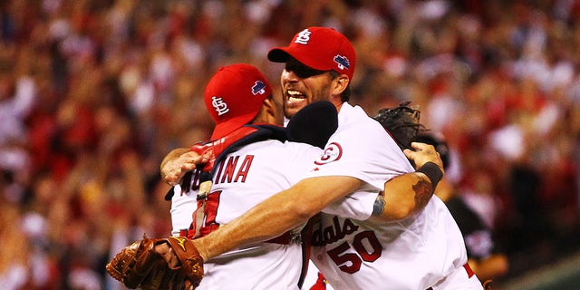 Adam Wainwright, right, celebrates with Yadier Molina of the St. Louis Cardinals after they defeated the Pittsburgh Pirates in Game 5 of the National League Division Series at Busch Stadium in St. Louis, Missouri, on Oct. 9, 2013.