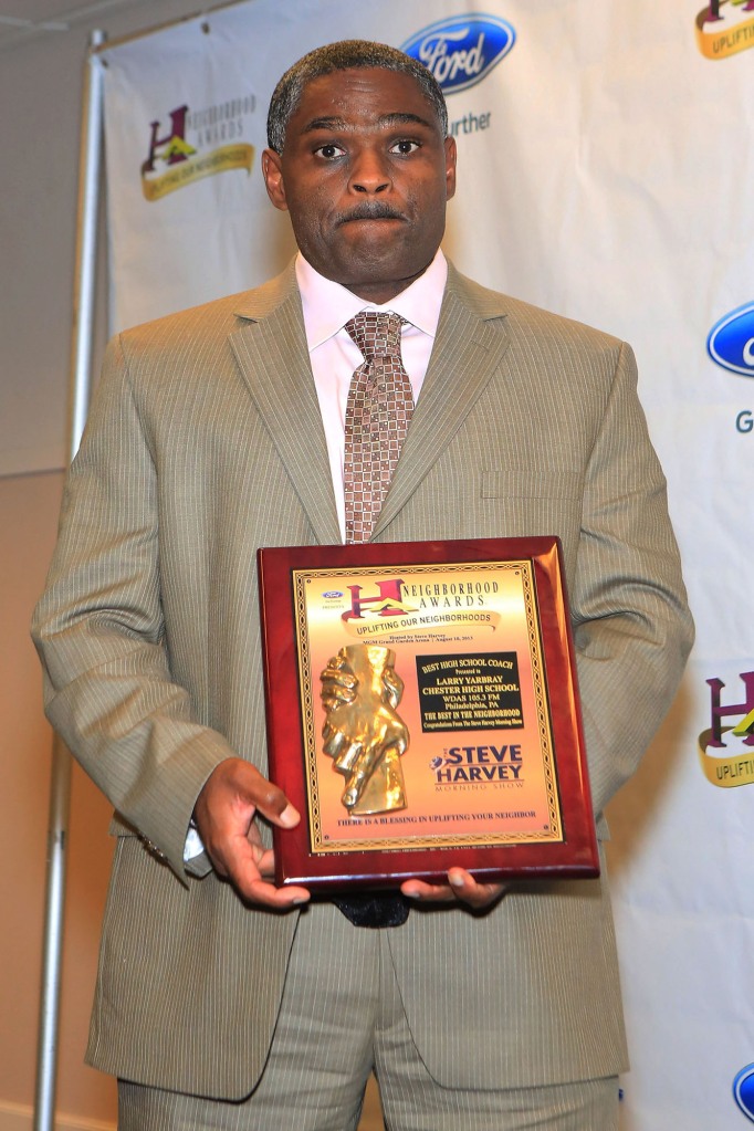 Larry Yarbray holds up his plaque for Best High School Coach on August 10, 2013 in Las Vegas, Nevada.  