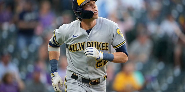 Milwaukee Brewers' Christian Yelich follows the flight of his solo home run off Colorado Rockies starting pitcher Chad Kuhl in the first inning of a baseball game Tuesday, Sept. 6, 2022, in Denver.