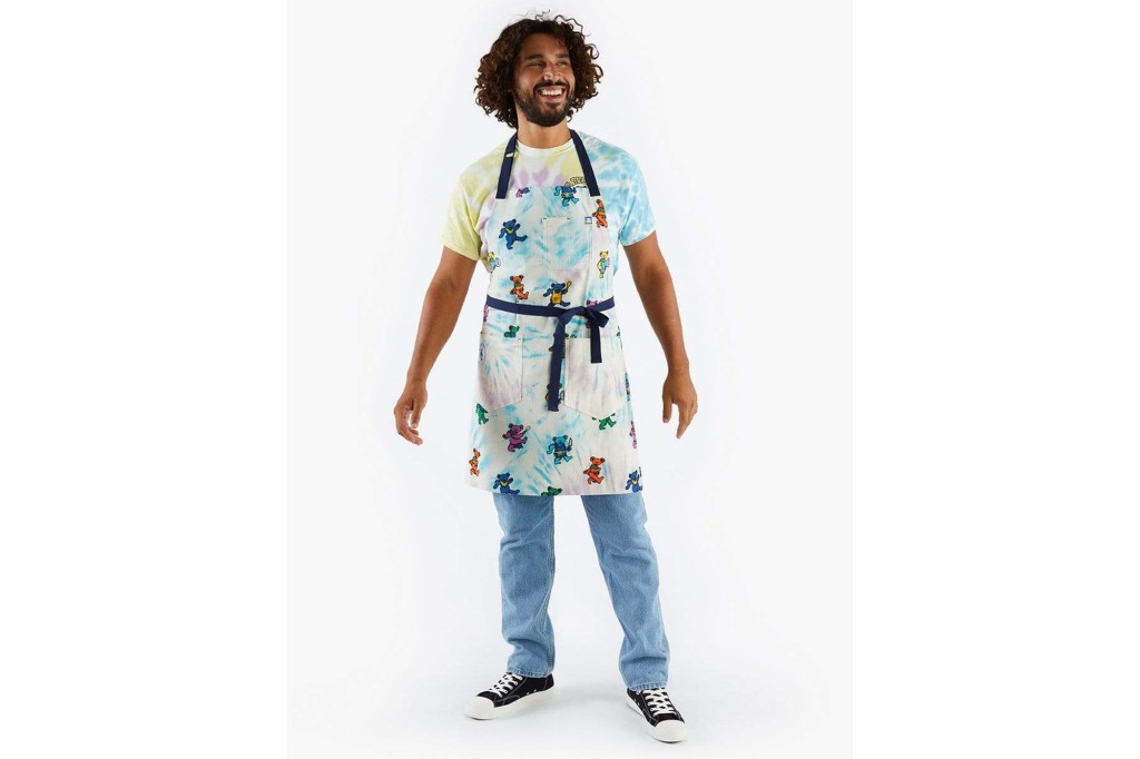 A man in a tie dye apron with bears on it 