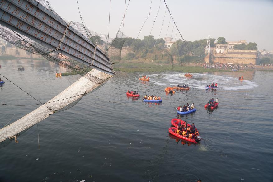 National Disaster Response Force (NDRF) police and military personnel work at the site of the collapsed bridge in Morbi, Gujarat, India, on Oct. 31, 2022.