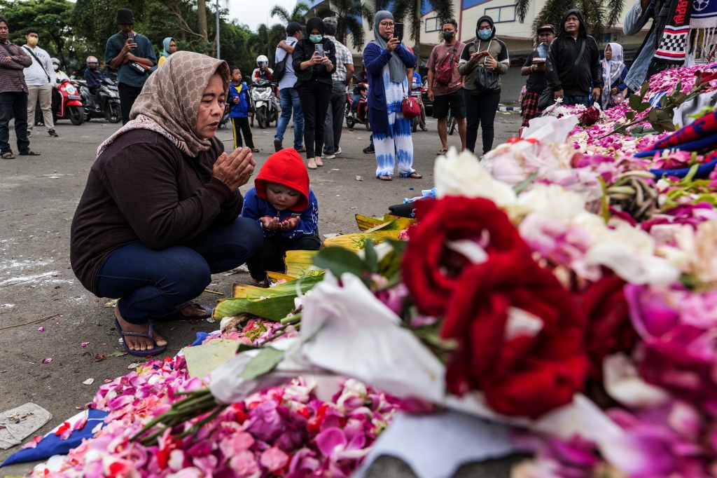 Supporters and people lay flowers as they pay condolence to the victims outside Kanjuruhan Stadium on Oct. 03, 2022 in Malang, Indonesia. 