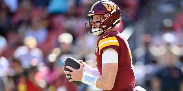 Carson Wentz of the Washington Commanders drops back to pass against the Tennessee Titans at FedEx Field on Oct. 9, 2022, in Landover, Maryland.