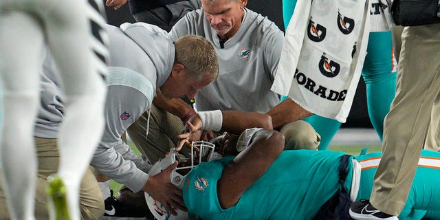 Miami Dolphins quarterback Tua Tagovailoa is examined during the first half of the team's game against the Cincinnati Bengals Thursday, Sept. 29, 2022, in Cincinnati. 